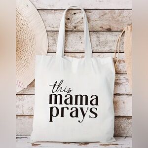 Canvas tote bag that says “this mama prays”.  Brand new and never used.